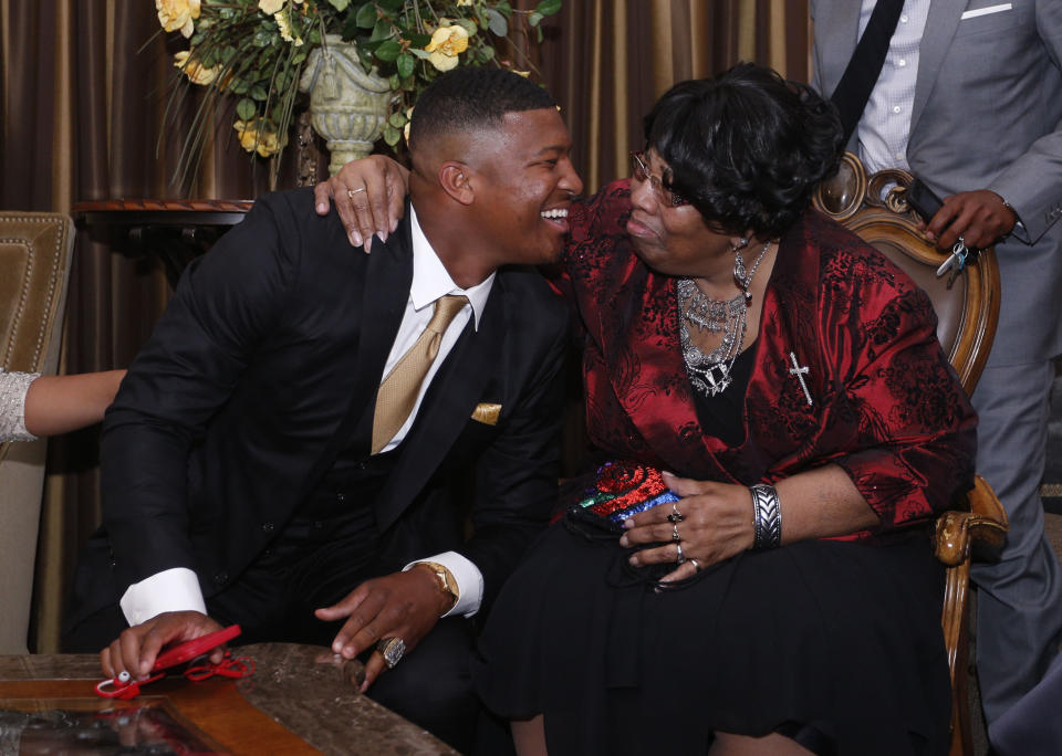 James Winston reacts with his grandmother Myrtle Winston to learning he is the first pick in the NFL draft Thursday, April 30, 2015 in Bessemer, Ala. Winston was drafted by the Tampa Bay Buccaneers. (AP Photo/Hal Yeager)