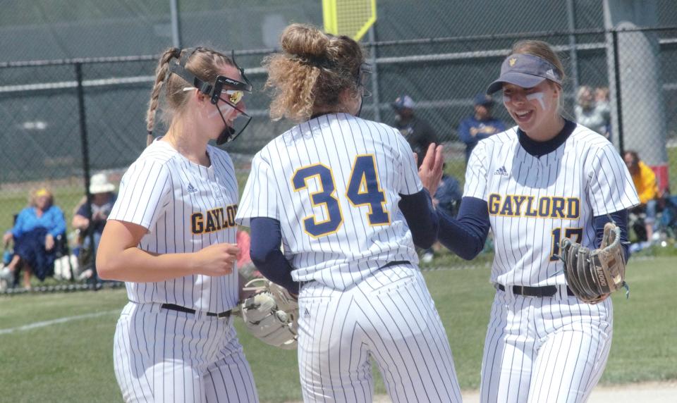 Alexis Kozlowski (left), Avery Parker (center) and Jayden Jones (right) celebrate during the MHSAA Division 2 district semifinal game with Gladwin on Saturday, June 4 at Petoskey High School.