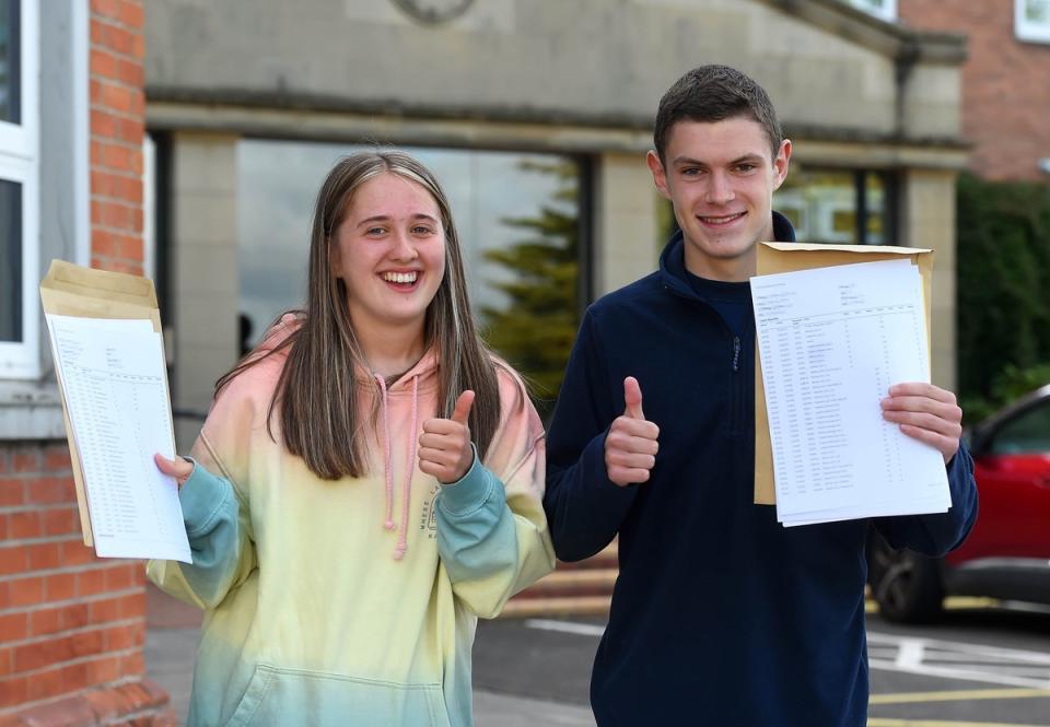 Grace McLaughlin and Jamie Morris celebrate their results at Sullivan Upper School (Oliver McVeigh/PA) (PA Wire)