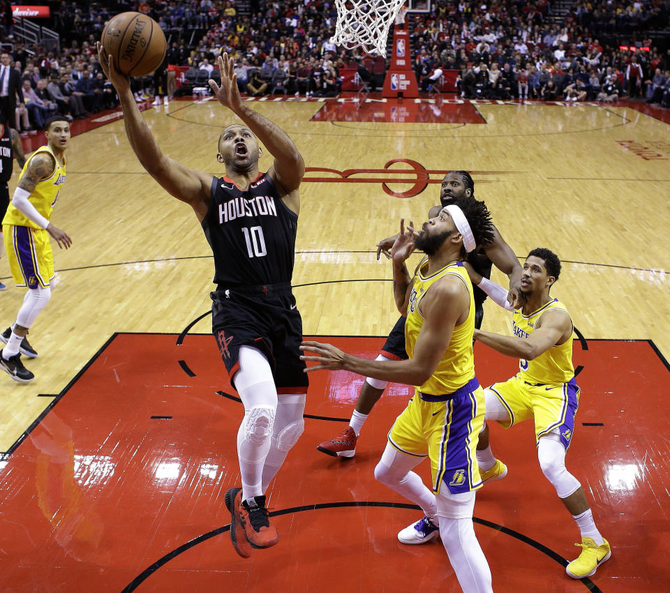Houston Rockets guard Eric Gordon (10) drives to the basket past Los Angeles Lakers center JaVale McGee, right front, during the first half of an NBA basketball game Saturday, Jan. 19, 2019, in Houston. (AP Photo/Eric Christian Smith)