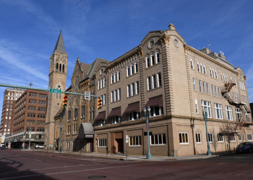 A brown building at the intersection. 