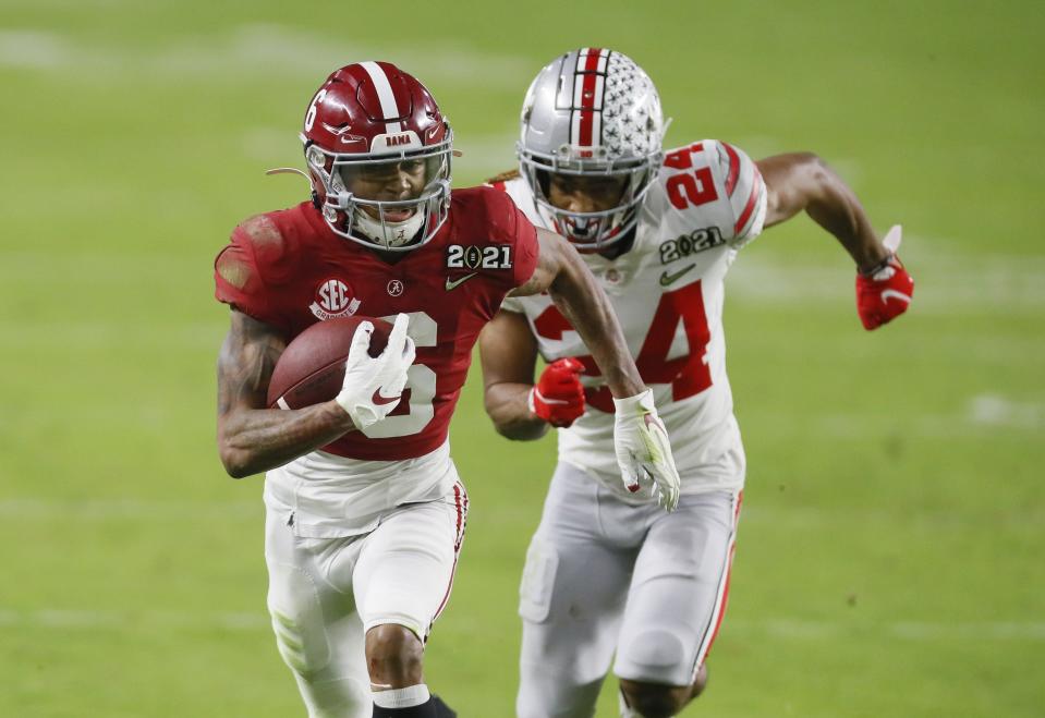Jan. 11, 2021; Miami Gardens, Florida, USA; Alabama Crimson Tide wide receiver DeVonta Smith (6) runs upfield after catching a pass behind the defense of Ohio State Buckeyes cornerback Shaun Wade (24) during the second quarter of the College Football Playoff National Championship at Hard Rock Stadium in Miami Gardens, Fla. Mandatory Credit: Kyle Robertson/The Columbus Dispatch/USA TODAY Network