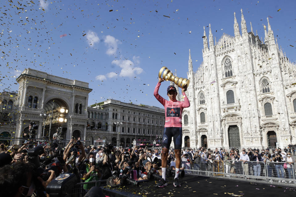 Colombia's Egan Bernal celebrates on podium after completing the final stage to win the Giro d'Italia cycling race, in Milan, Italy, Sunday, May 30, 2021. (AP Photo/Luca Bruno)