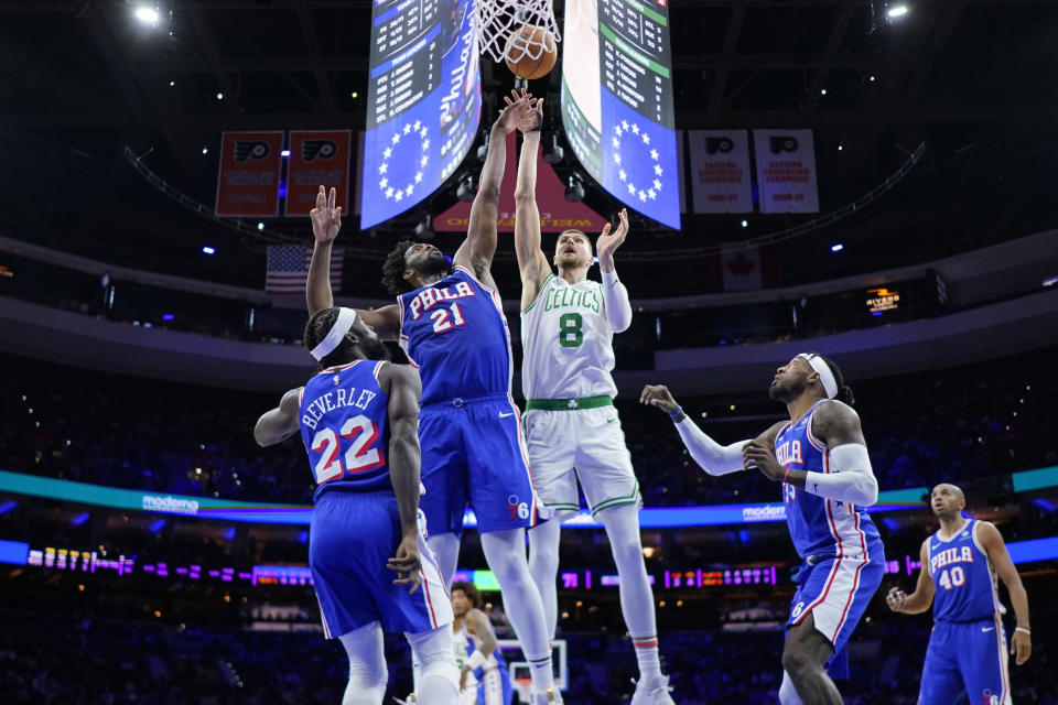 Boston Celtics' Kristaps Porzingis (8) goes up for a shot against Philadelphia 76ers' Joel Embiid (21) during the second half of an NBA basketball game, Wednesday, Nov. 8, 2023, in Philadelphia. (AP Photo/Matt Slocum)