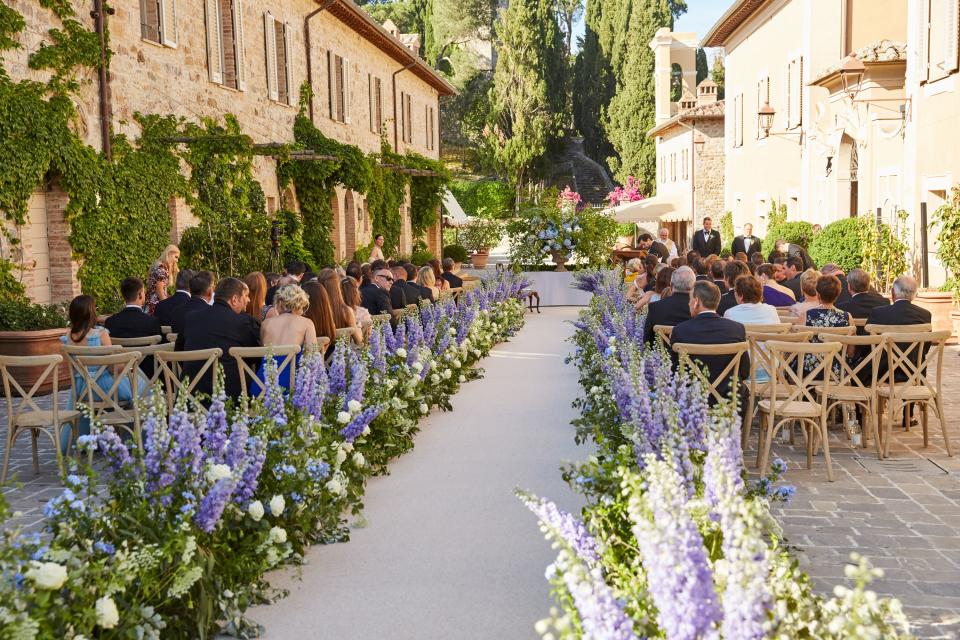 It ran through the center of Castiglion del Bosco, a departure from the estate’s typical ceremony location (they’re usually held either in the ruins or overlooking the hills). Event planner Alex Fitzgibbons felt an aisle the length of the stone pathway provided the most dramatic entrance for the bride.