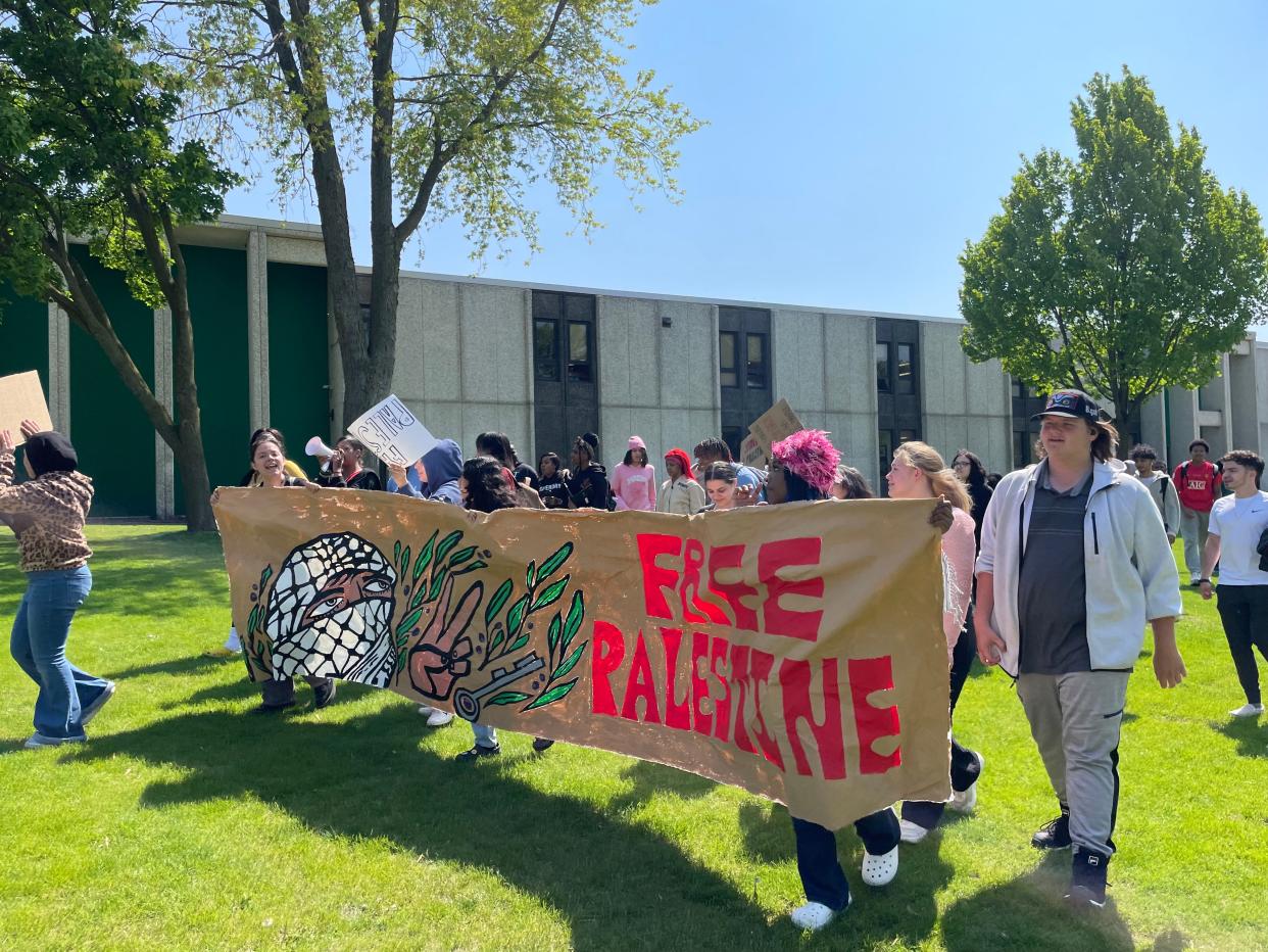 Students from Alexander Hamilton High School hold a "Free Palestine" sign outside their school Wednesday in Milwaukee.