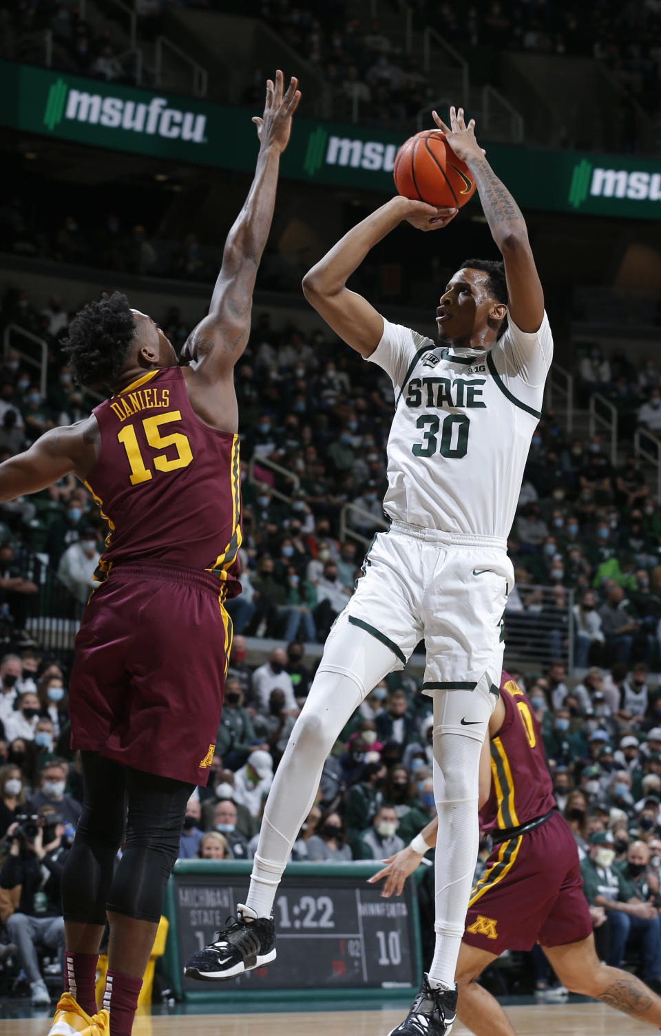 Michigan State's Marcus Bingham Jr., right, shoots over Minnesota's Charlie Daniels during the first half of an NCAA college basketball game, Wednesday, Jan. 12, 2022, in East Lansing, Mich. (AP Photo/Al Goldis)
