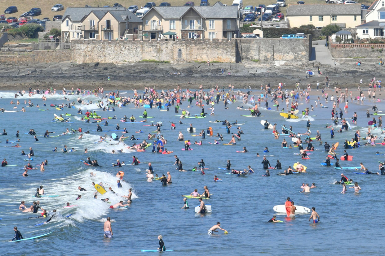 People in the sea at Croyde Beach in North Devon as another spell of warm weather hits the UK.