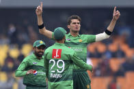 Pakistan pacer Shaheeh Shah Afridri, center, celebrates with teammates after taking the wicket of Bangladesh batsman Mohammad Naim during the second T20 cricket match at Gaddafi stadium, in Lahore, Pakistan, Saturday, Jan. 25, 2020. (AP Photo/K.M. Chaudary)