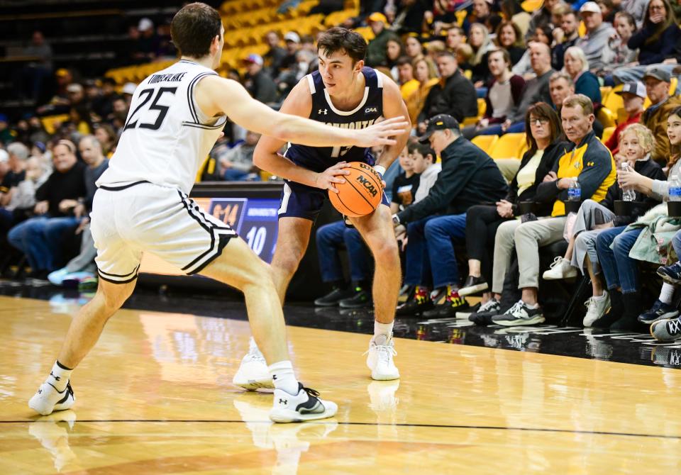 Monmouth guard Jack Collins works against Towson guard Nick Timberlake at SECU Arena in Towson, Maryland on Jan. 14, 2023.