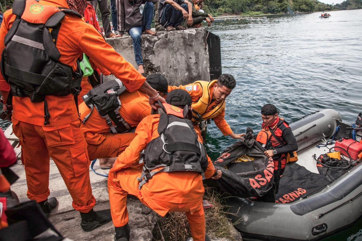 Rescue team members search for missing passengers at the Lake Toba ferry port: AFP/Getty Images