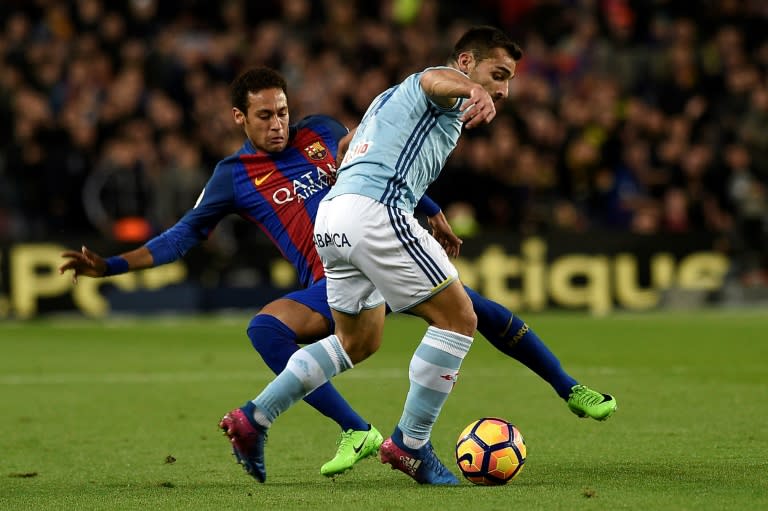 Barcelona's forward Neymar (L) vies with Celta Vigo's defender Jonny Castro during the Spanish league football match March 4, 2017