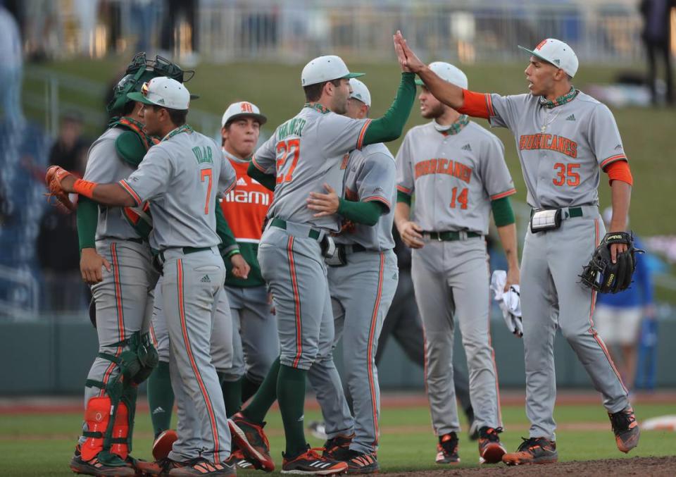Ben Wanger (center, No. 27) is shown celebrating with teammates after he earned his first UM baseball victory in the 13th inning against the Florida Gators at Florida Ballpark in Gainesville on Saturday, Feb. 20, 2021.