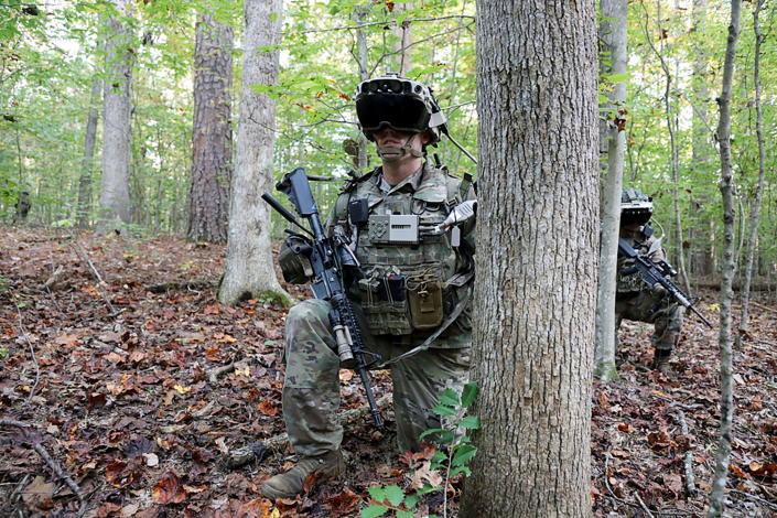 Soldiers in the woods at Fort Pickett wearing IVAS prototypes. 