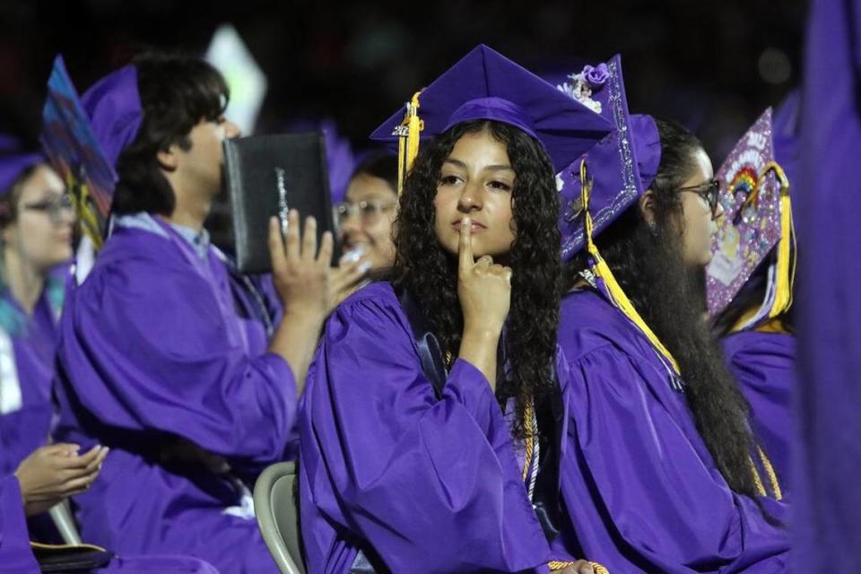 A Madera South High graduate ponders the moment during the graduation ceremony at Madera Memorial Stadium on June 7, 2023.