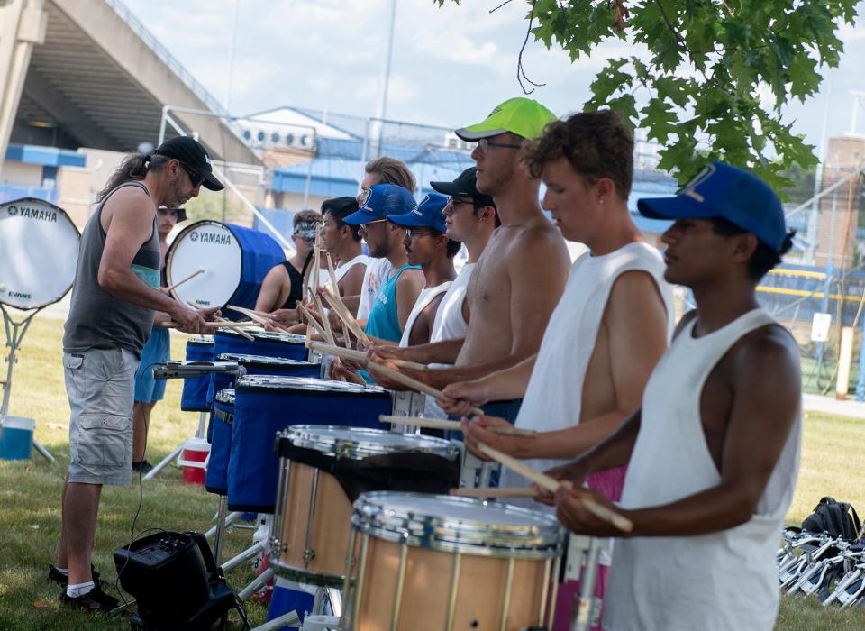 Canton Bluecoats Drum & Bugle Corps member Roger Carter leads a drum practice this week at Dix Stadium in Kent. The Bluecoats are celebrating its 50th anniversary this year and have three special shows planned this Fourth of July weekend in Kent and Canton.