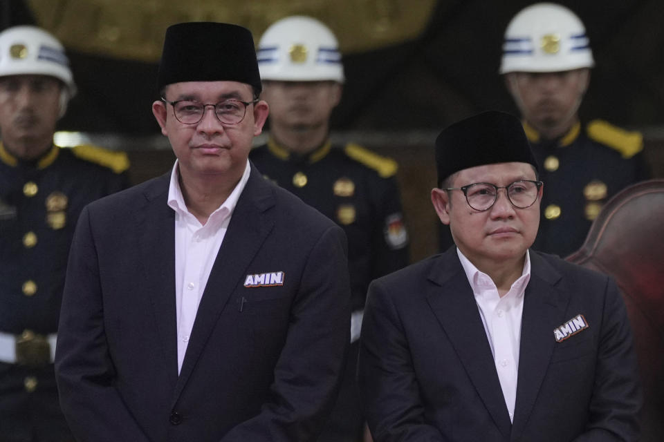 Presidential candidate Anies Baswedan, left, and his running mate Muhaimin Iskandar stand on the stage during the signing ceremony of the "Declaration of Peaceful Election Campaign" at the General Election Commission Building in Jakarta, Indonesia, Monday, Nov. 27, 2023. Indonesia's presidential hopefuls vowed a peaceful race on Monday, a day before campaigning for next year's election officially began as concerns rose their rivalry may sharpen religious and ethnic divides in Southeast Asia's largest democracy. (AP Photo/Tatan Syuflana)