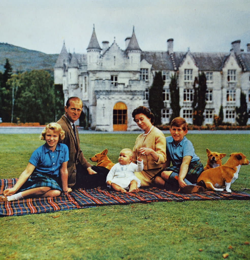 Photograph of Queen Elizabeth II with her husband, Prince Philip, and their children at Balmoral Castle. <span class="copyright">Universal Images Group—Getty Images</span>