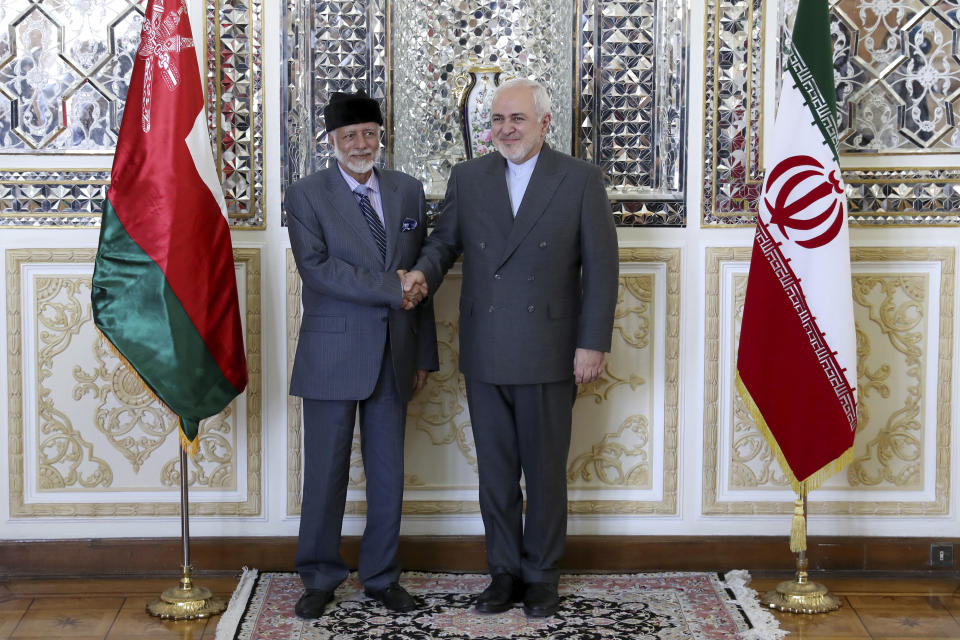 Iranian Foreign Minister Mohammad Javad Zarif, right, and his Omani counterpart Yousuf bin Alawi pose for a photo prior to their meeting, in Tehran, Iran, Saturday, July 27, 2019. (AP Photo/Ebrahim Noroozi)