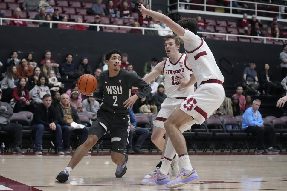 Washington State guard Myles Rice (2) drives to the basket against Stanford guard Michael Jones, middle, and forward Maxime Raynaud during the first half of an NCAA college basketball game in Stanford, Calif., Thursday, Jan. 18, 2024. (AP Photo/Jeff Chiu)