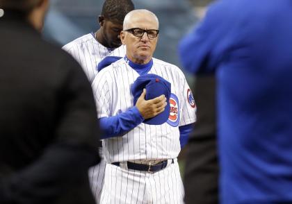 Chicago Cubs manager Joe Maddon stands for a tribute to Ernie Banks before Sunday's game. (AP)