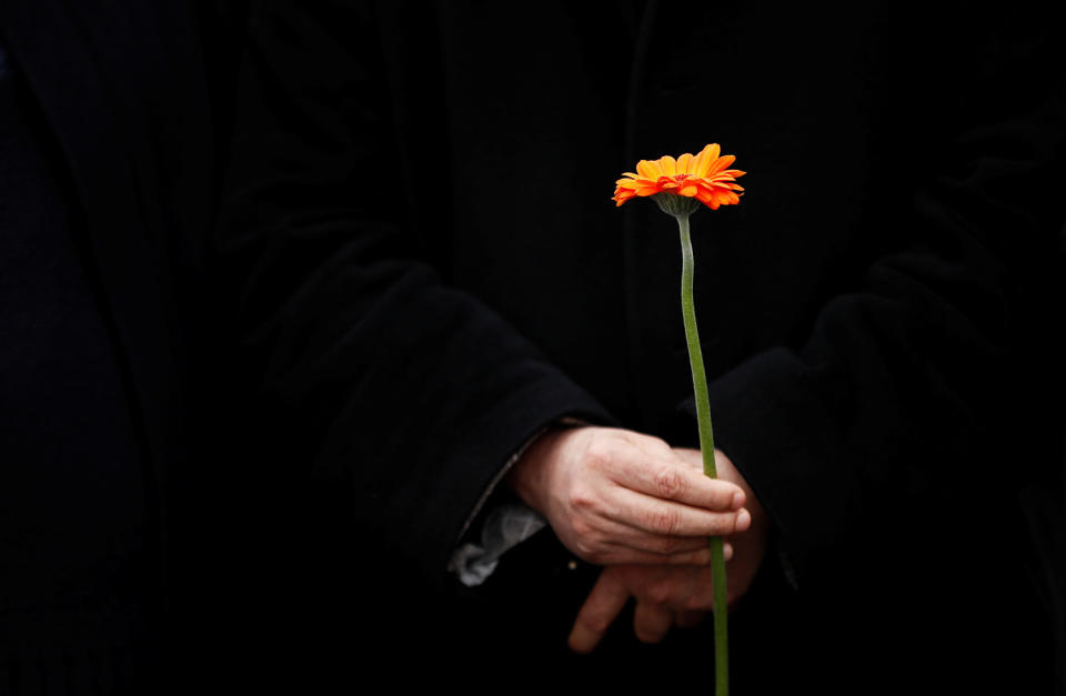 A muslim man holds a flower in London