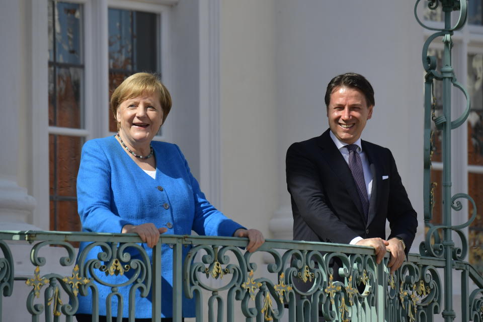 German Chancellor Angela Merkel, left, and Italian Prime Minister Guiseppe Conte, right, talk prior to a meeting at the German government's guest house 'Meseberg' in Gransee, north of Berlin, Germany, Monday, July 13, 2020. (Tobias Schwarz/Pool Photo via AP)