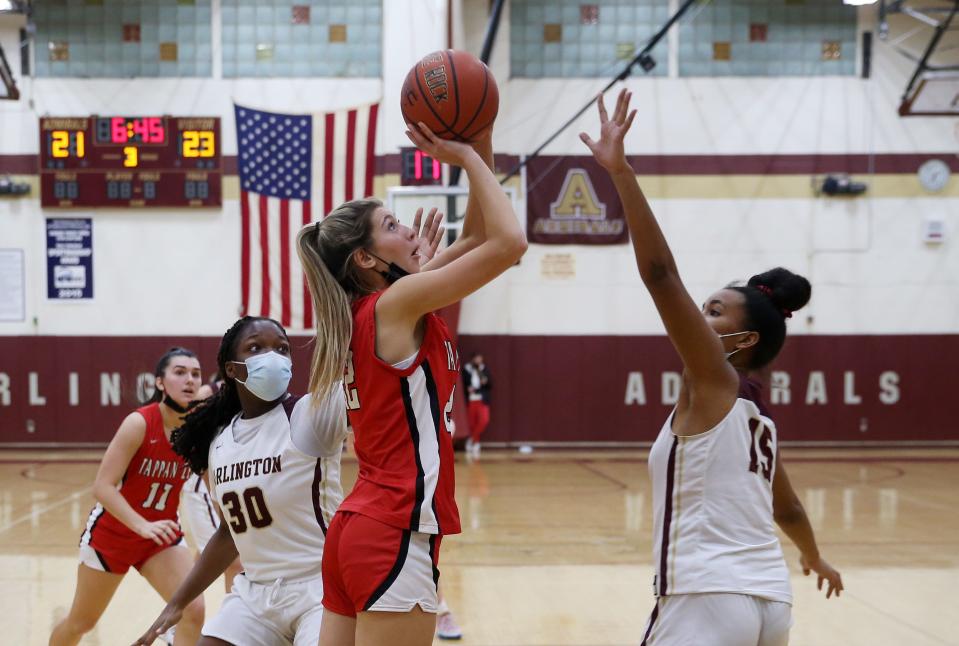 Tappan Zee's Brooke Comito (22) goes up for a shot in front of Arlington's Maya Watts (15) during girls basketball action at Arlington High School in Freedom Plains Jan. 26, 2022. Tappan Zee won the game 57-47.