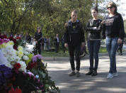 People commemorate the victims of the attack on a vocational college, in Kerch, Crimea, Thursday, Oct. 18, 2018. Authorities on the Crimean Peninsula were searching for a possible accomplice of the student who carried out a shooting and bomb attack on a vocational school Wednesday, killing 20 people and wounding more than 50 others, an official said Thursday. (AP Photo)