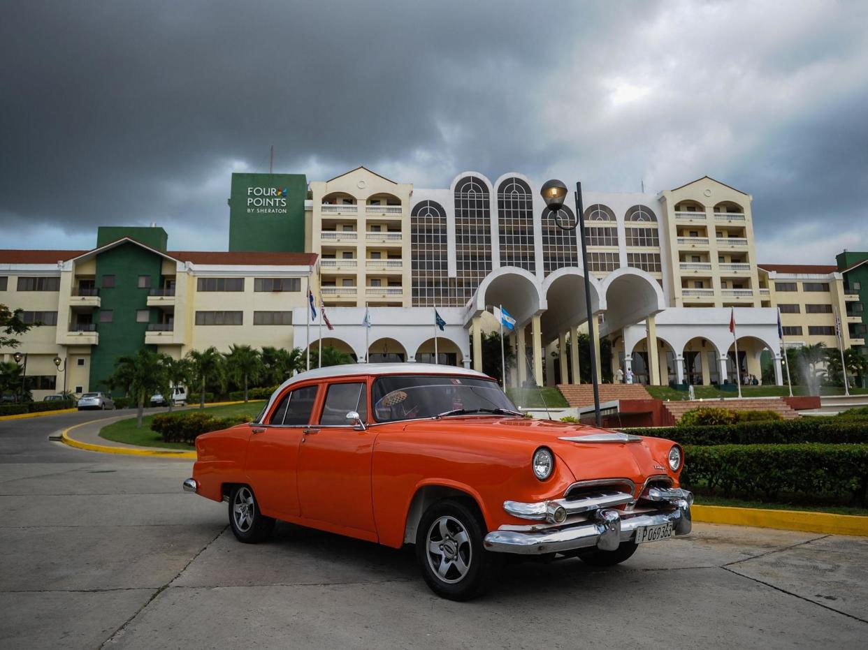 A vintage car passes in front of the Four Points by Sheraton hotel in Havana: (AFP)