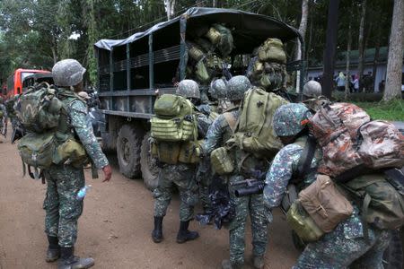 Members of the Philippine Marine Battalion Landing Team (MBLT) with their belongings onboard a military truck during their send-off ceremony ending their combat duty against pro-Islamic State militant groups inside a military headquarters in Marawi city, southern Philippines October 21, 2017, a few days after President Rodrigo Duterte announced the liberation of Marawi city. REUTERS/Romeo Ranoco