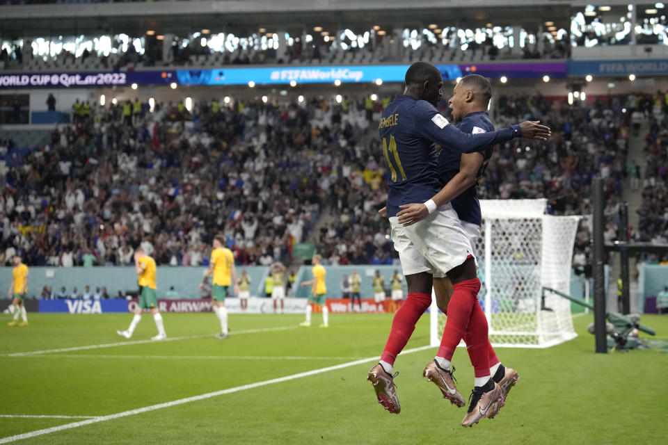 France's Kylian Mbappe, right, celebrates with his teammate Ousmane Dembele after scoring against Australia during the World Cup group D soccer match between France and Australia, at the Al Janoub Stadium in Al Wakrah, Qatar, Tuesday, Nov. 22, 2022. (AP Photo/Christophe Ena)