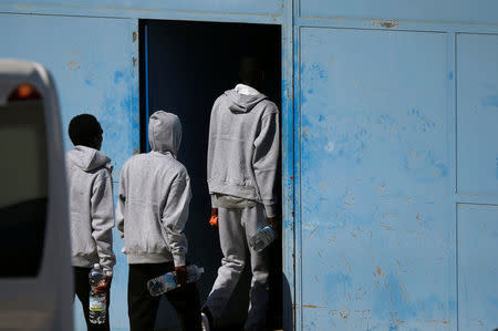 Migrants, intercepted by the NGO Proactiva Open Arms rescue boat in central Mediterranean Sea, enter to the new Center for Temporary Assistance to Foreigners (CATE) after arriving at the port of Algeciras in San Roque, southern Spain August 9, 2018. REUTERS/Jon Nazca