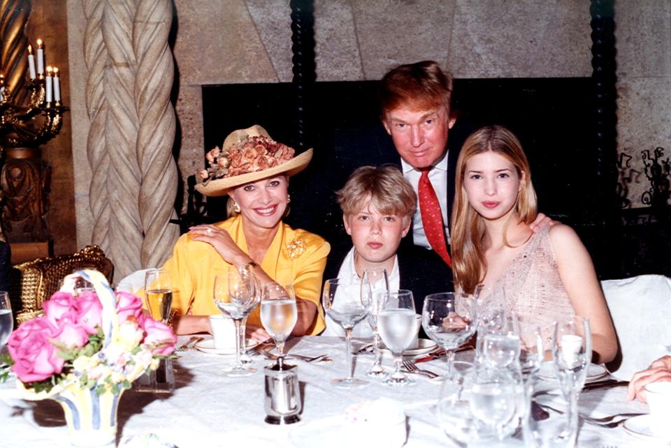 Family portrait of, from left, socialite Ivana Trump, her son Eric Trump, her former husband businessman Donald Trump, and her daughter Ivanka Trump as they sit at a table at the Mar-a-Lago estate, Palm Beach, Florida, 1998. (Photo by Davidoff Studios/Getty Images)