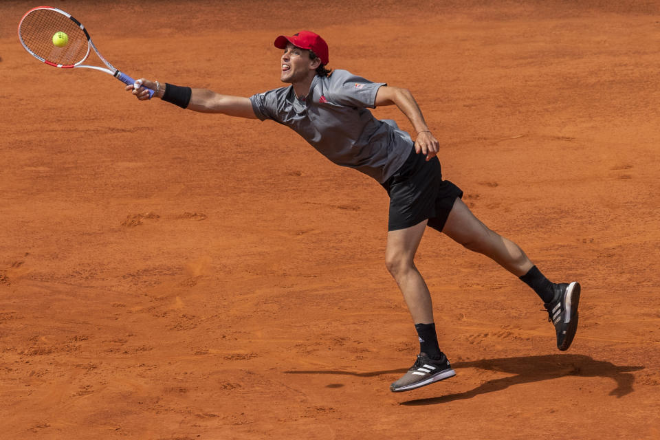 Austria's Dominic Thiem returns the ball to Germany's Alexander Zverev during their semi-final match at the Mutua Madrid Open tennis tournament in Madrid, Spain, Saturday, May 8, 2021. (AP Photo/Bernat Armangue)