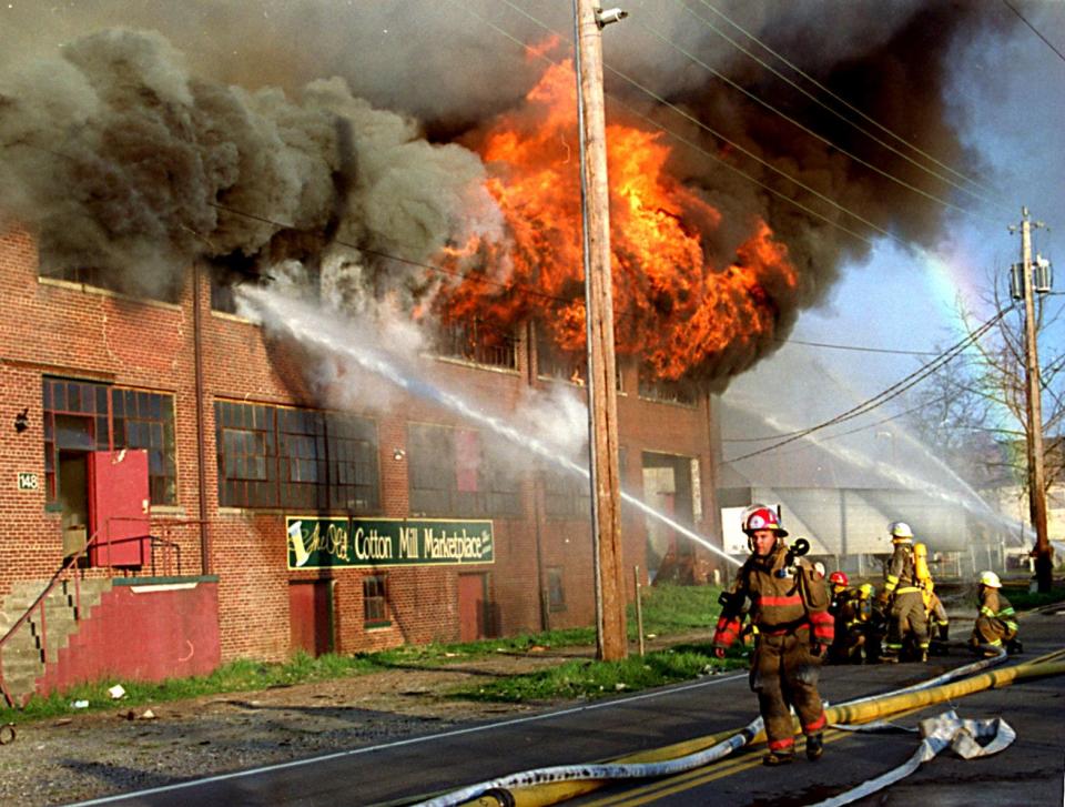 Asheville firefighters battle the blaze that consumed the Asheville Cotton Mill on April 2, 1995.