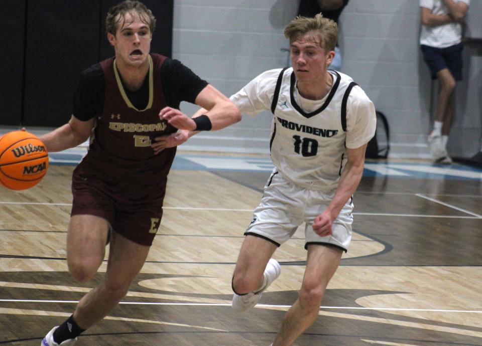 Episcopal guard Kent Jackson (2) dribbles up the court as Providence guard Caleb McAbee (10) defends during the District 3-3A boys basketball final. McAbee led a defensive effort that held Episcopal scoreless for 11 consecutive minutes on Friday.