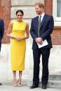 <p>Taking a break from her <a href="https://www.cosmopolitan.com/uk/fashion/celebrity/a21611097/meghan-markle-neutral-colours-clothes/" rel="nofollow noopener" target="_blank" data-ylk="slk:neutral coloured wardrobe;elm:context_link;itc:0;sec:content-canvas" class="link ">neutral coloured wardrobe</a>, Meghan flawed us in this bright yellow shift dress by American designer Brandon Maxwell. It is thought that Meghan has stuck to a neutral colour palette when attending events with the Queen, in order not to upstage her Majesty. But as Queenie was nowhere to be seen, Meghan went bright, although she kept her shoes neutral in nude Manolo Blahnik heels.</p>