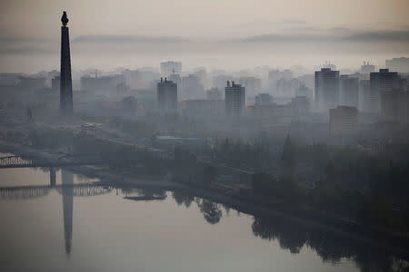 FILE PHOTO: The 170-metre (558-feet) tall Juche Tower is reflected in Taedong River as morning fog blankets Pyongyang, North Korea May 5, 2016. To match Special Report NORTHKOREA-VINALON/ REUTERS/Damir Sagolj/File Photo
