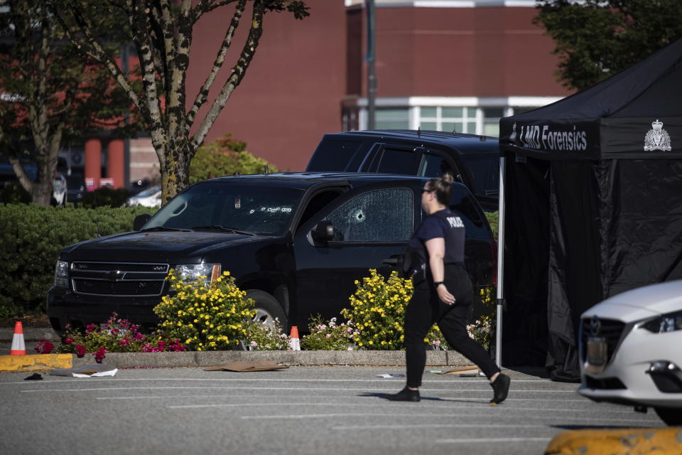 Bullet holes are seen in the windshield and passenger window of an RCMP vehicle at the scene of a shooting in Langley, British Columbia, Monday, July 25, 2022. Canadian police reported multiple shootings of homeless people Monday in a Vancouver suburb and said a suspect was in custody. (Darryl Dyck/The Canadian Press via AP)