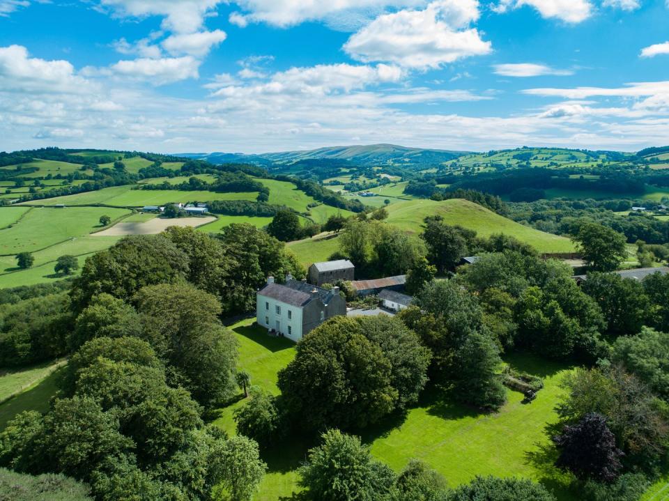 <p>Surrounded by idyllic countryside, this breathtaking home is situated on the edge of the Brecon Beacons National Park — just three miles from Prince Charles' Welsh home, Llwynywermod. </p><p><a href="https://www.knightfrank.co.uk/properties/residential/for-sale/llangadog-carmarthenshire-sa19/cho012087863" rel="nofollow noopener" target="_blank" data-ylk="slk:This property is currently for sale for £2,750,000 via Knight Frank;elm:context_link;itc:0;sec:content-canvas" class="link ">This property is currently for sale for £2,750,000 via Knight Frank</a>. </p>