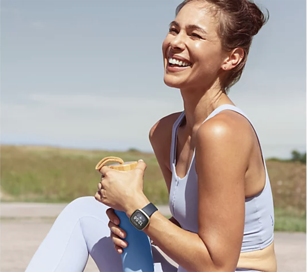 Fitbit Versa 3 on a woman in workout clothing.