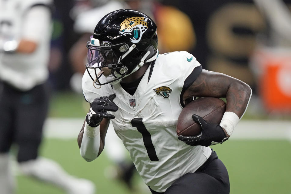 Jacksonville Jaguars running back Travis Etienne Jr. (1) runs for yardage against the New Orleans Saints in the first half of an NFL football game in New Orleans, Thursday, Oct. 19, 2023. (AP Photo/Gerald Herbert)
