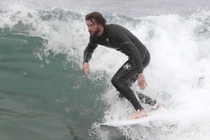 Liam Hemsworth strips off at the beach