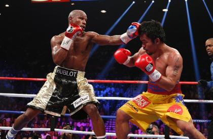 Floyd Mayweather and Manny Pacquiao exchange punches during their May 2, 2015 bout. (AFP)