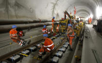 Workers have a break during the installation of the railway tracks in the NEAT Gotthard Base tunnel near Erstfeld May 7, 2012. Crossing the Alps, the world's longest train tunnel should become operational at the end of 2016. The project consists of two parallel single track tunnels, each of a length of 57 km