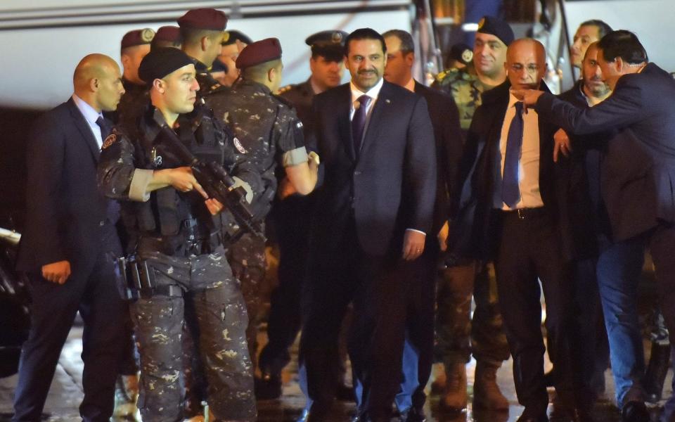 Lebanese Prime Minister Saad Hariri (C) arrives at Beirut International Airport on November 21, 2017. - AFP