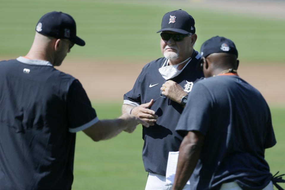 Detroit Tigers' manager Ron Gardenhire, center, talks with two of his coaches as baseball training camp begins at Comerica Park, Friday, July 3, 2020, in Detroit. (AP Photo/Duane Burleson)