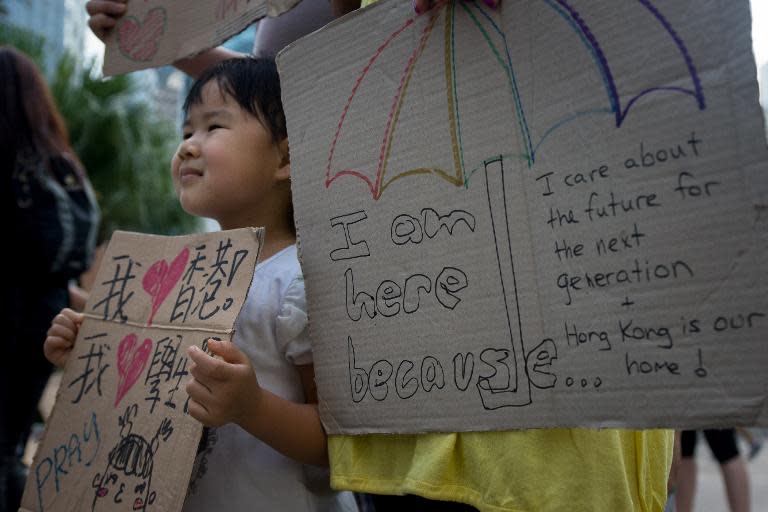 A young girl holds a placard during Hong Kong's pro-democracy protests, on October 1, 2014