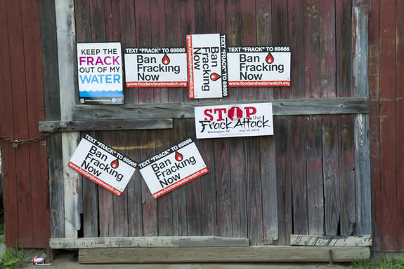 Signs protest fracking on the side of a barn in Pennsylvania.